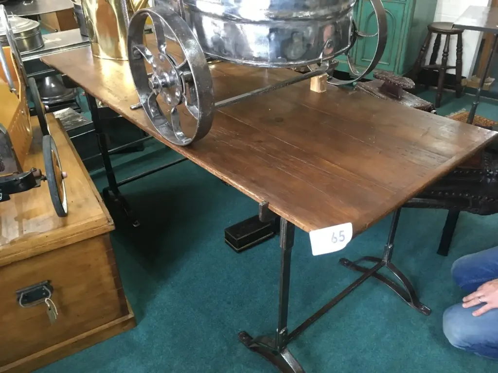 antique table with a wooden top and metal legs found while antique shopping in England