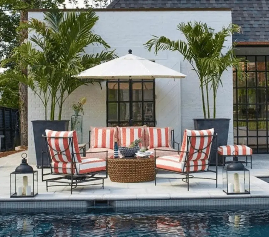 Fun poolside outdoor lounge featuring striped white and red chairs