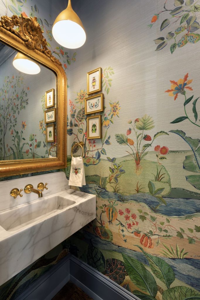 Palm Beach interiors powder room with botanical wallpaper, marble sink, and ornate gold mirror