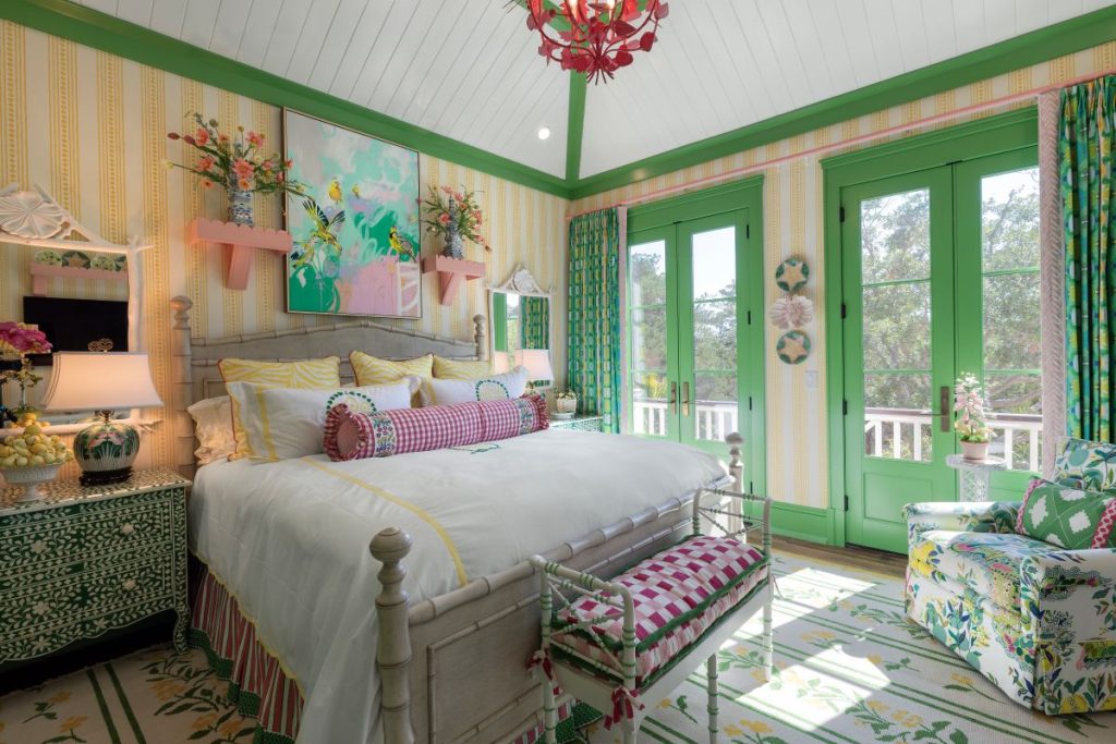 Room with gingham bolster and a tropical print wallpaper styled with Palm Beach interior design